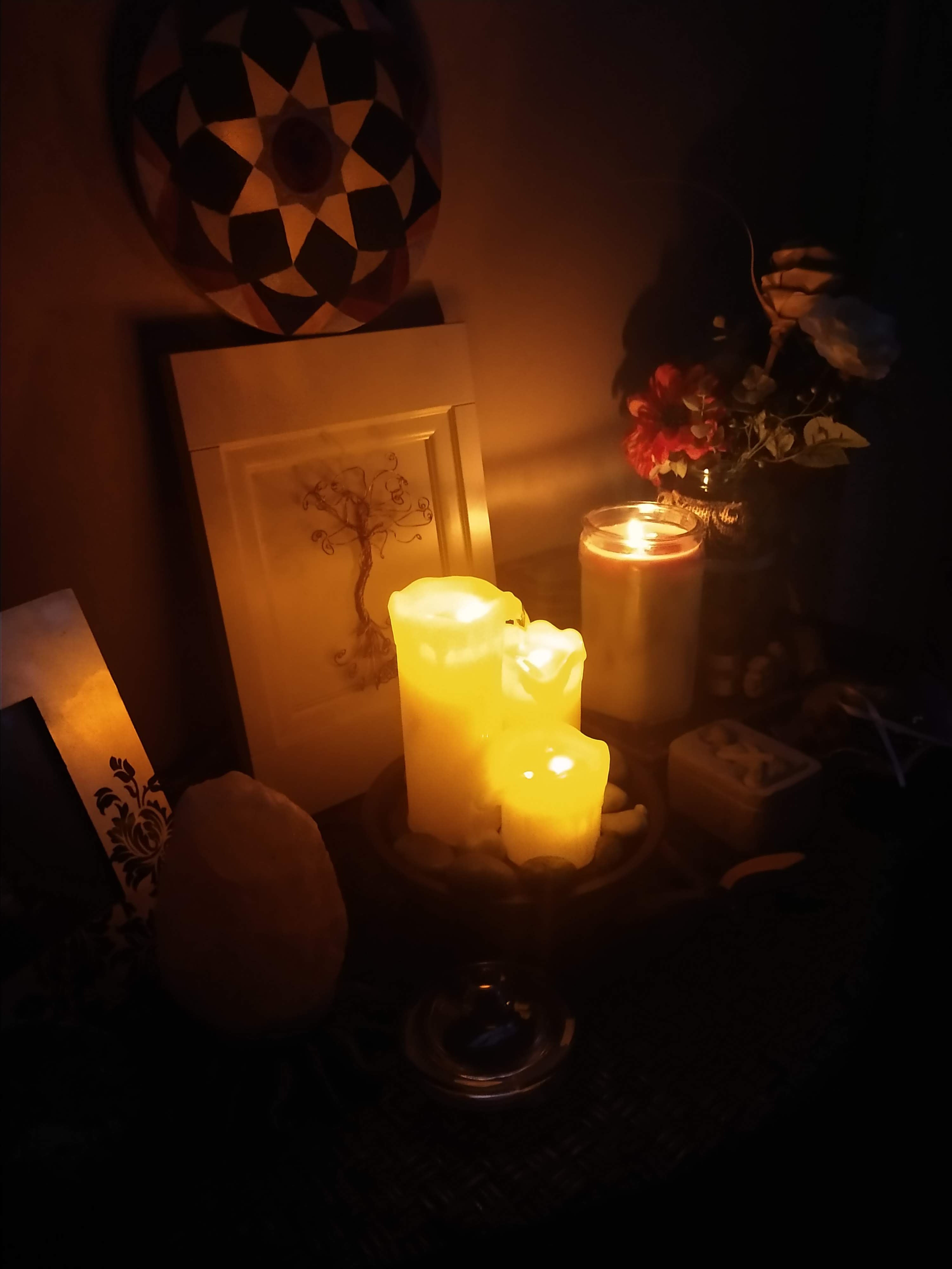candles burning at night on table with small decor around