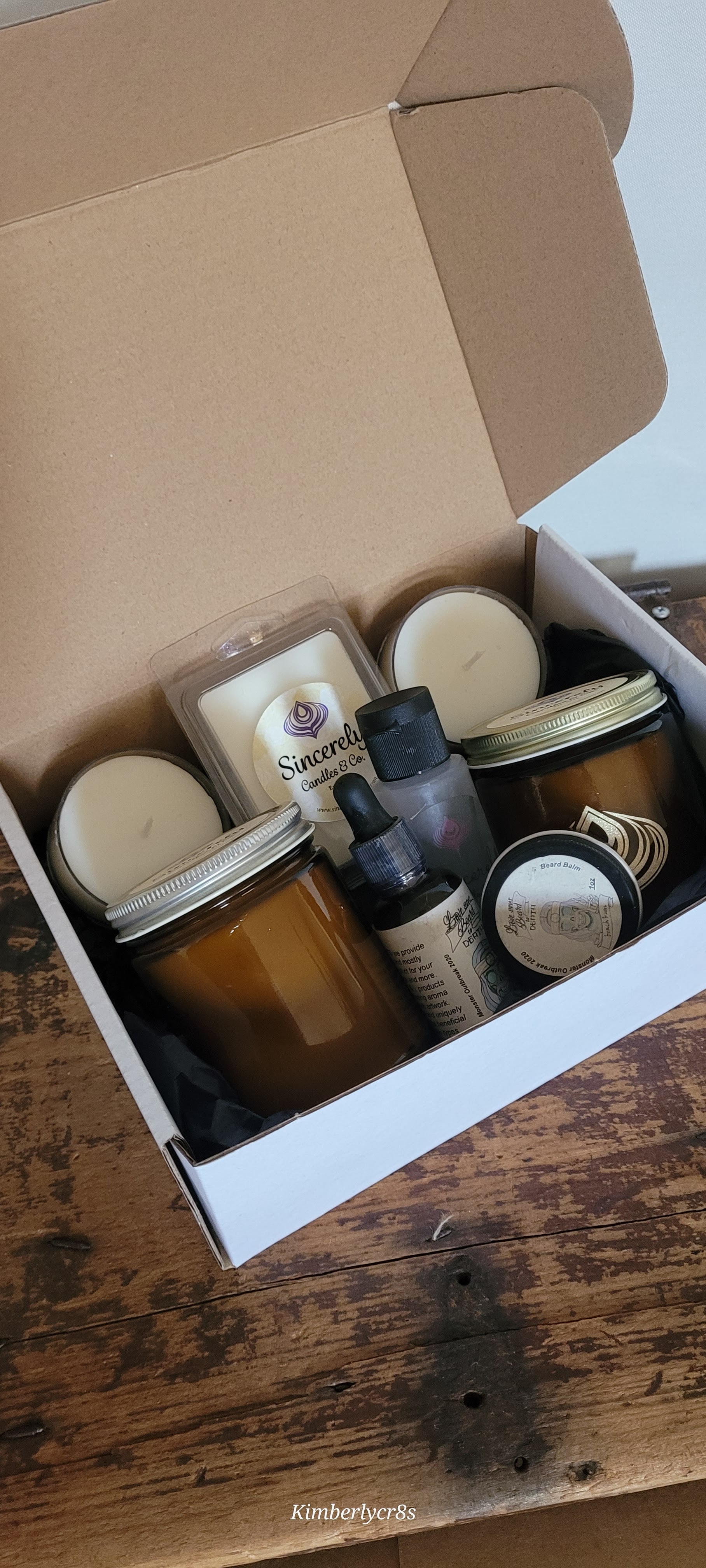 Box containing various jars and bottles on a wooden surface