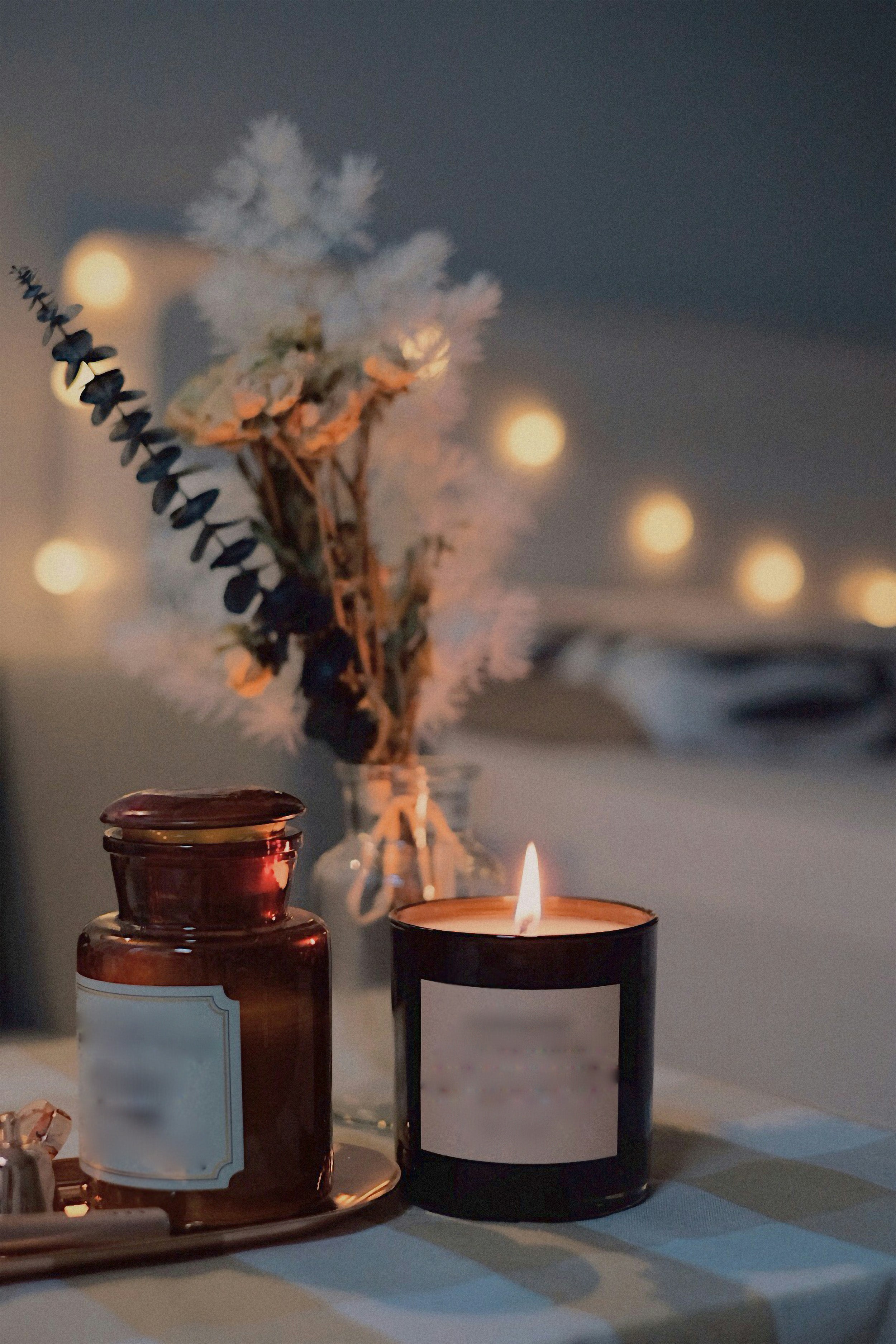 Candle and decorative items on a table with a blurred background